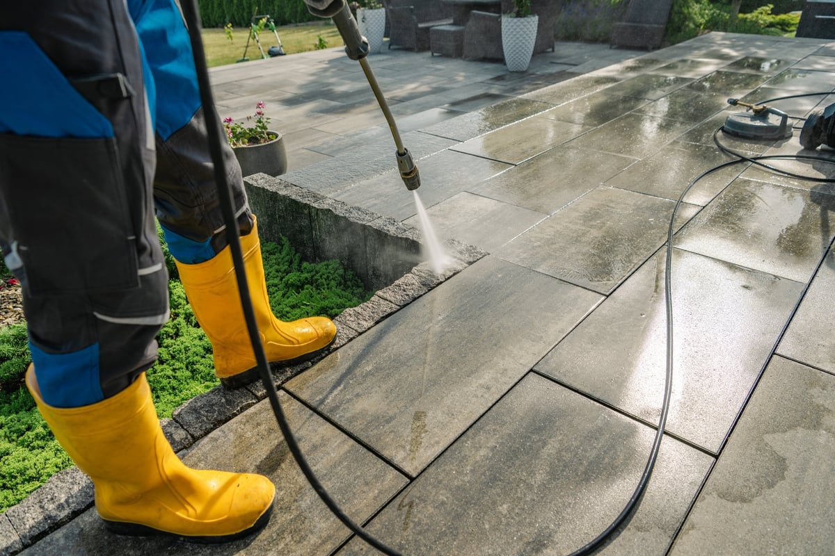 Stone patio being pressure washed